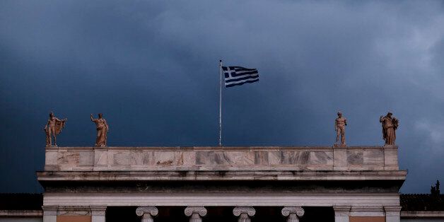 The Greek flag flutters on the Archeological Museum in Central Athens. December 23, 2016. (Photo by Kostis Ntantamis/NurPhoto via Getty Images)