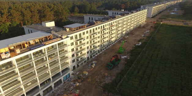 BINZ, GERMANY - JUNE 15: In this aerial view blocks of the Prora building complex stretch along the beach on Ruegen Island on June 15, 2017 in Binz, Germany. Prora was originally commissioned by Adolf Hitler as a massive, 4.5 kilometers long beach holiday resort complex for German workers under a program called Strength through Joy (Kraft durch Freude). The original plans called for a festival hall to hold 20,000 people and rooms located in eight, 450 meter-long blocks to accomodate 20,000 guests, with each room facing the sea. Construction halted in 1939 and after World War II the complex housed Soviet soldiers, then East German Army units before the German government, having assumed administration after 1989, sold the five exisitng blocks to private investors. Today Prora is a massive real estate development, with some parts still in ruins while others include a hotel, holiday apartments, a museum and documentation center and a youth hostel. (Photo by Sean Gallup/Getty Images)