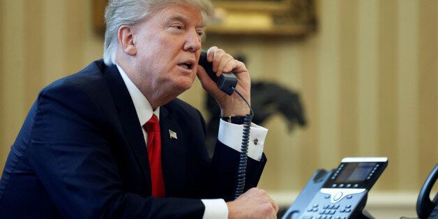 U.S. President Donald Trump speaks by phone with the Saudi Arabia's King Salman in the Oval Office at the White House in Washington, U.S. January 29, 2017. REUTERS/Jonathan Ernst