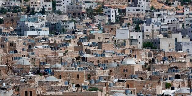 A picture taken on June 29, 2017 shows a view of the houses in the old town of the divided city of Hebron in the southern West Bank.On July 7, 2017 UNESCO declared in a secret ballot the Old City of Hebron in the occupied West Bank a protected heritage site.Hebron is home to more than 200,000 Palestinians, and a few hundred Israeli settlers who live in a heavily fortified enclave near the site known to Muslims as the Ibrahimi Mosque and to Jews as the Cave of the Patriarchs. / AFP PHOTO / HAZEM BADER (Photo credit should read HAZEM BADER/AFP/Getty Images)