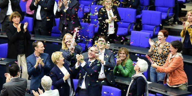 MPÂ´s from the Green party celebrate with confetti following a debate and vote on same-sex marriage in Bundestag, GermanyÂ´s lower house of Parliament in Berlin on June 30, 2017.A clear majority of German MPs voted to legalise same-sex marriage, days after Chancellor Angela Merkel dropped her opposition to the idea. / AFP PHOTO / Tobias SCHWARZ (Photo credit should read TOBIAS SCHWARZ/AFP/Getty Images)
