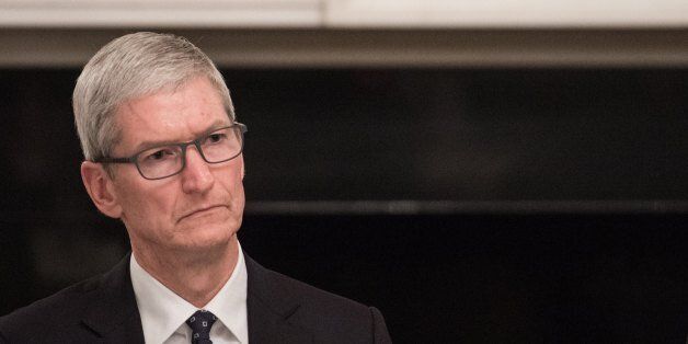 Apple CEO Tim Cook listens to a speaker during an American Technology Council roundtable at the White House in Washington, DC, on June 19, 2017. / AFP PHOTO / NICHOLAS KAMM (Photo credit should read NICHOLAS KAMM/AFP/Getty Images)