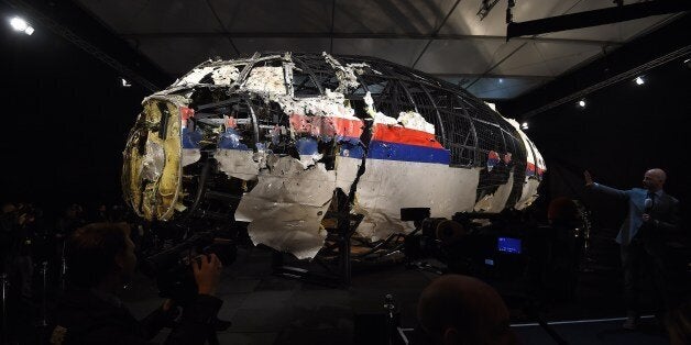 The wrecked cockipt of the Malaysia Airlines flight MH17 is presented to the press during a presentation of the final report on the cause of the its crash at the Gilze Rijen airbase October 13, 2015. Air crash investigators have concluded that Malaysia Airlines flight MH17 was shot down by a missile fired from rebel-held eastern Ukraine, sources close to the inquiry said today, triggering a swift Russian denial. The findings are likely to exacerbate the tensions between Russia and the West, as ties have strained over the Ukraine conflict and Moscow's entry into the Syrian war. AFP PHOTO / EMMANUEL DUNAND (Photo credit should read EMMANUEL DUNAND/AFP/Getty Images)