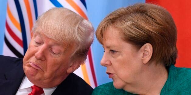 US President Donald Trump (L) and German Chancellor Angela Merkel attend a panel discussion on the second day of the G20 Summit in Hamburg, Germany, July 8, 2017.Leaders of the world's top economies gather from July 7 to 8, 2017 in Germany for likely the stormiest G20 summit in years, with disagreements ranging from wars to climate change and global trade. / AFP PHOTO / SAUL LOEB (Photo credit should read SAUL LOEB/AFP/Getty Images)