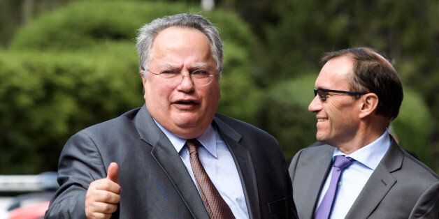 Greek Foreign Minister Nikos Kotzias (L) gives a thumb next to UN envoy Espen Barth Eide upon his arrival for the opening of Cyprus peace talks on June 28, 2017 in the Swiss resort of Crans-Montana.Rival Cypriot leaders meet to resume efforts to solve one of the world's longest-running political crises in what the island's UN envoy billed as the 'best chance' for peace. The make-or-break talks in Switzerland are geared towards ending the decades-old division of the island and striking a lasting deal between its Greek- and Turkish-speaking communities. / AFP PHOTO / Fabrice COFFRINI (Photo credit should read FABRICE COFFRINI/AFP/Getty Images)
