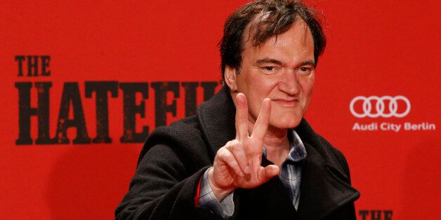 Director Quentin Tarantino gestures as he arrives for the German premiere of