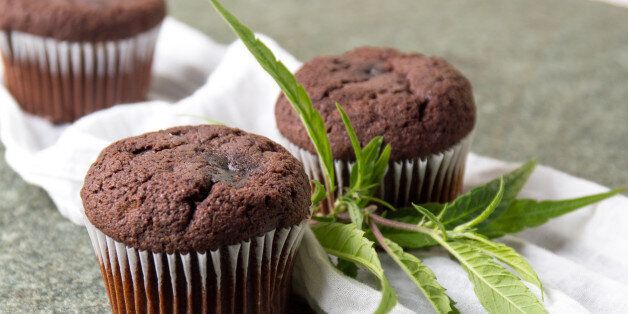 Chocolate muffins with Marijuana leaves on stone table
