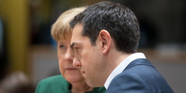 Alexis Tsipras, Greece's prime minister, right, and Angela Merkel, Germany's chancellor, speak ahead of round table talks during the European Union (EU) summit in Brussels, Belgium, on Friday, March 10, 2017. European Union leaders sent a clear signal that the 28-nation bloc will promote free trade, in a show of opposition to the protectionist stance floated by the new U.S. administration. Photographer: Jasper Juinen/Bloomberg via Getty Images