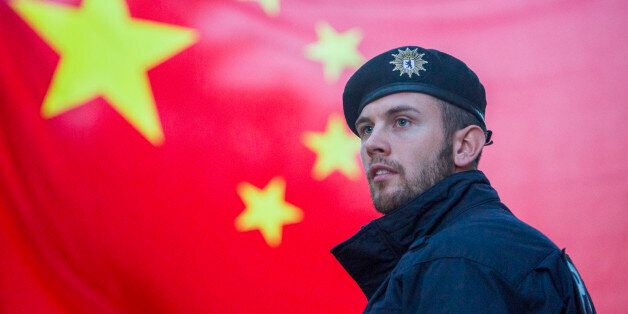A German policeman is seen securing the area were Chinese students gathered in a display of support, near Hotel Adlon in Berlin prior to the arrival of the President of the People's Republic of China, Xi Jinping, on July 4, 2017. Xi Jinping and Angela Merkel will meet tomorrow at the Chancellery in the German capital. (Photo by Omer Messinger/NurPhoto via Getty Images)