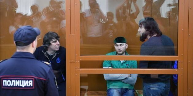 From L: Temirlan Eskerkhanov, Shadid Gubashev and Zaur Dadayev, charged with masterminding and carrying out the assassination of politician Boris Nemtsov, are seen inside a defendants' cage during a hearing at the Moscow District Military Court on June 27, 2017.The jury is set to start deliberations on its verdict at the end of the marathon trial of five men accused of organising and carrying out the killing of Russian opposition leader Boris Nemtsov in 2015. / AFP PHOTO / Kirill KUDRYAVTSEV (Photo credit should read KIRILL KUDRYAVTSEV/AFP/Getty Images)