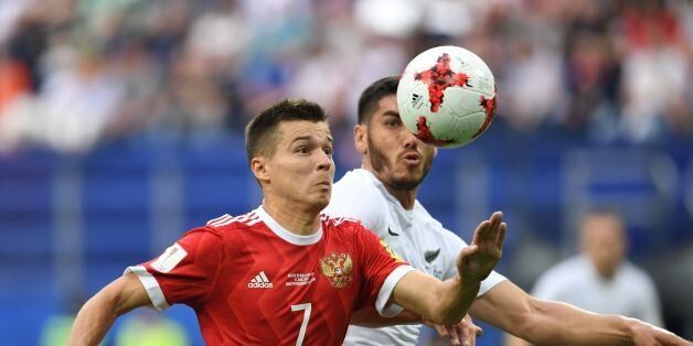 Russia's forward Dmitry Poloz (L) vies for the ball against New Zealand's defender Michael Boxall during the 2017 Confederations Cup group A football match between Russia and New Zealand at the Krestovsky Stadium in Saint-Petersburg on June 17, 2017.Russia beat New Zealand 2-0. / AFP PHOTO / Kirill KUDRYAVTSEV (Photo credit should read KIRILL KUDRYAVTSEV/AFP/Getty Images)