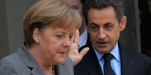 France's President Nicolas Sarkozy (R) accompanies German Chancellor Angela Merkel as she leaves the Elysee Palace in Paris, February 6, 2012 following a Franco-German intergovernmental meeting. REUTERS/Philippe Wojazer (FRANCE - Tags: POLITICS)