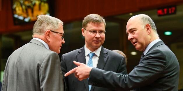European Stability Mechanism (ESM) Managing Director Klaus Regling (L) talks with European Commission vice president Valdis Dombrovskis (C) and EU Economic Affairs Commissioner Pierre Moscovici during an Ecofin meeting at the EU headquarters in Brussels on July 11, 2017. / AFP PHOTO / JOHN THYS (Photo credit should read JOHN THYS/AFP/Getty Images)