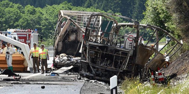 Policemen and forensic experts work at the scene where a tour bus burst into flames following a collision with a trailer truck on the highway A9 near MÃ¼nchberg, southern Germany, on July 3, 2017, where up to 17 people are feared dead / AFP PHOTO / Christof STACHE (Photo credit should read CHRISTOF STACHE/AFP/Getty Images)