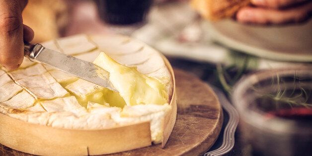 Baked Camembert cheese with garlic and rosemary. This soft, creamy and surface-ripened milk cheese is a delicious snack.