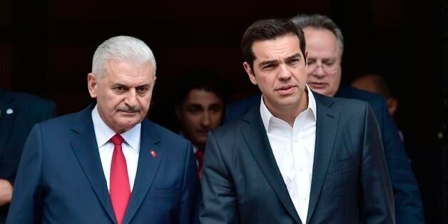 Greek Prime Minister Alexis Tsipras (R) walks next to his Turkish counterpart Binali Yildirim after their talks in Athens on June 19, 2017. Yildirim visits Greece to discuss Cyprus ahead of the resumption of UN-backed peace talks on June 28. / AFP PHOTO / LOUISA GOULIAMAKI (Photo credit should read LOUISA GOULIAMAKI/AFP/Getty Images)