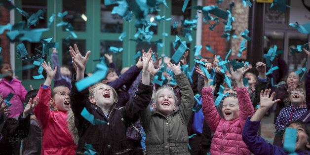 HULL, ENGLAND - JUNE 29: Young children catch paper helicopters falling from the sky as the world's most popular colour of Marrs Green is revealed during the exhibition 'Paper City' as part of Hull UK City of Culture 2017 on June 29, 2017 in Hull, England. After a major global survey by Hull-based paper company, G . F Smith, the world's favourite colour was revealed by launching Marrs Green paper helicopters in to the air during Hull UK City of Culture's latest show 'Paper City'. The exhibition also includes eight large scale paper sculptures by some of the UK's leading designers and architects. (Photo by Christopher Furlong/Getty Images)