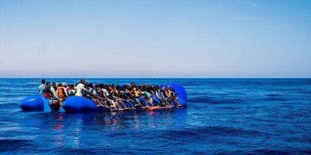 MEDITERRANEAN SEA, LIBYA - JUNE 15 : Spanish SAR plane patrols as refugees wait to get on onboard the rescue vessel Golfo Azzurro by members of the Spanish NGO Proactiva Open Arms, after being rescued from a wooden boat sailing out of control in the Mediterranean Sea near Libya on Thursday, June 15, 2017. A Spanish aid organization Thursday rescued 420 migrants who were attempting the perilous crossing of the Mediterranean Sea to Europe in packed boats from Libya. (Photo by Marcus Drinkwater/An