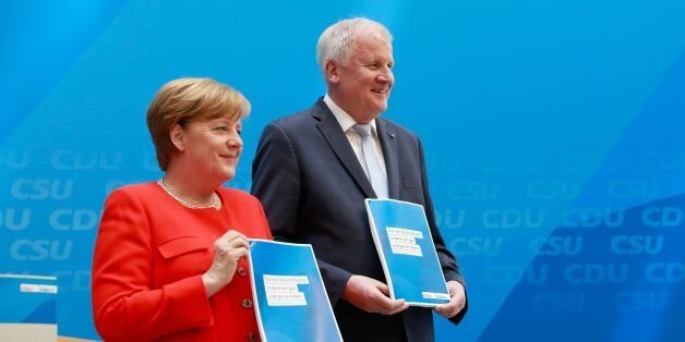 German Chancellor and head of the Christian Democrats party, Angela Merkel (L) and Horst Seehofer, leader of Bavarian sister Party CSU, present their parties' electoral programmes for the September 24 parliamentary election during a press conference on July 3, 2017 in Berlin. / AFP PHOTO / Odd ANDERSEN (Photo credit should read ODD ANDERSEN/AFP/Getty Images)