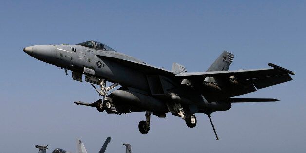 A F/A-18E Super Hornet of Strike Fighter Squadron (VFA-31) comes in to land onboard the flight deck of the aircraft carrier USS George H.W. Bush (CVN 77), in the Gulf August 12, 2014. Planes have been taking off from the USS George H.W. Bush (CVN77) to strike key positions taken over by the Islamic State fighters in Iraq. U.S. President Barack Obama has authorised air strikes to confront the Islamist fighters in various cities of Iraq. REUTERS/Hamad I Mohammed (MID-SEA - Tags: POLITICS CIVIL UNR