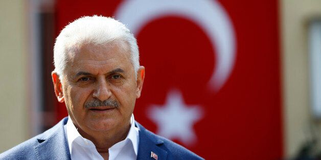 Turkish Prime Minister Binali Yildirim speaks to media next to a polling station during a referendum in the Aegean port city of Izmir, Turkey, April 16, 2017. REUTERS/Osman Orsal