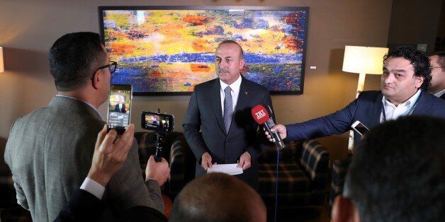 CRANS-MONTANA, SWITZERLAND - JUNE 29: Turkish Foreign Minister Mevlut Cavusoglu (C) answers press' questions after Conference on Cyprus in Crans-Montana, Switzerland on June 29, 2017. (Photo by Cem Ozdel/Anadolu Agency/Getty Images)