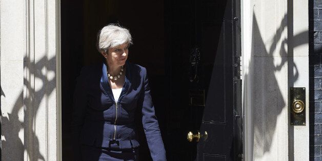 Britain's Prime Minister Theresa May exits No 10 Downing St to greet Ukraine Prime Minister, Volodymyr Groysman, in central London on July 5, 2017. / AFP PHOTO / NIKLAS HALLE'N (Photo credit should read NIKLAS HALLE'N/AFP/Getty Images)