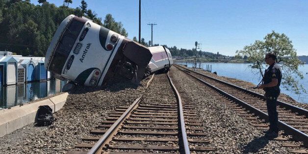 A derailed Amtrak passenger train lies on its side before the Chambers Bay Bridge on Puget Sound in Steilacoom, Washington, U.S. July 2, 2017. West Pierce Fire Department/Handout via REUTERS ATTENTION EDITORS - THIS PICTURE WAS PROVIDED BY A THIRD PARTY. THIS PICTURE WAS PROCESSED BY REUTERS TO ENHANCE QUALITY. AN UNPROCESSED VERSION HAS BEEN PROVIDED SEPARATELY.?