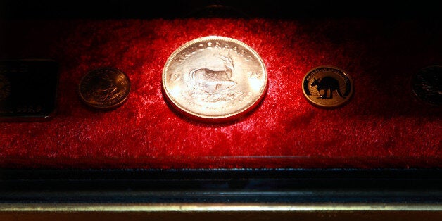 Gold coins dispensed from the first gold-plated automated teller machine (ATM) in Europe sit on display at the Westin Palace Hotel, in Madrid, Spain, on Wednesday, Sept. 29, 2010. The machine, which features cutting-edge technology, dispenses 1g, 5g and 10g gold bars and also dispenses gold coins bearing designs such as Krugerrand, Maple Leaf and Kangaroo, which are sold in gift boxes at real-time prices, organizers said in the media release. Photographer: Liesa Johannssen/Bloomberg via Getty Images