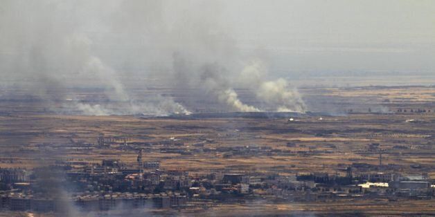 A picture taken from the Israeli-occupied Golan Heights shows smoke billowing from the Syrian side of the border on June 26, 2017.Israeli forces fired on Syria after several projectiles from the war-torn country hit the occupied Golan Heights, the army said, in the second such exchange in three days. / AFP PHOTO / JALAA MAREY (Photo credit should read JALAA MAREY/AFP/Getty Images)