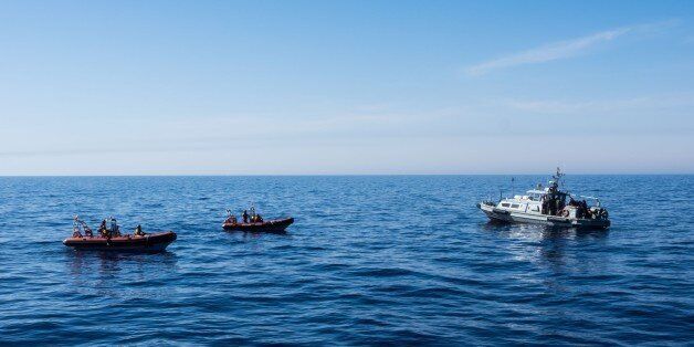 MEDITERRANEAN SEA, LIBYA - JUNE 15 : Spanish NGO Proactiva Open Arms and Libyan Coast Guards are seen in the Mediterranean Sea, near Libya on Thursday, June 15, 2017. A Spanish aid organization Thursday rescued 420 migrants who were attempting the perilous crossing of the Mediterranean Sea to Europe in packed boats from Libya. (Photo by Marcus Drinkwater/Anadolu Agency/Getty Images)