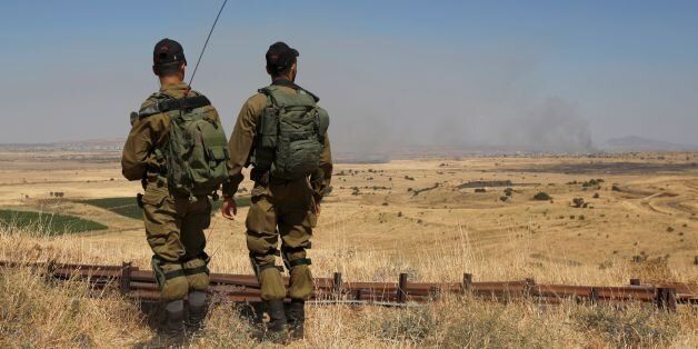 Israeli soldiers patrol near the border with Syria after projectiles fired from the war-torn country hit the Israeli occupied Golan Heights on June 24, 2017.An Israeli aircraft carried out a strike on Syria after 10 projectiles hit the occupied Golan Heights, an army spokesman said. The Israeli Air Force also targeted two tanks of the 'Syrian regime' in the northern part of the Golan, the spokesman said, adding the projectiles did not cause any casualties. / AFP PHOTO / JALAA MAREY (Photo credit should read JALAA MAREY/AFP/Getty Images)