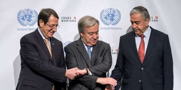 (L/R): Greek Cypriot President Nicos Anastasiades, UN Secretary General Antonio Guterres and Turkish Cypriot Leader Mustafa Akinci pose for a photograph during Cyprus peace talks in the Swiss resort of Crans-Montana on June 30, 2017.More than 40 years after Turkish troops invaded northern Cyprus, the presence of tens of thousands of soldiers on the Mediterranean island still looms large over make-or-break peace negotiations this week. / AFP PHOTO / Fabrice COFFRINI (Photo credit should re