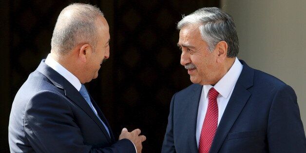 Turkey's Foreign Minister Mevlut Cavusoglu (L) and Turkish Cypriot leader Mustafa Akinci talk during a meeting in Nicosia, Cyprus May 26, 2015. REUTERS/Yiannis Kourtoglou