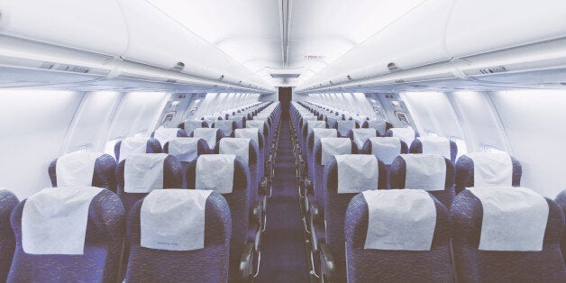 Modern Airplane seats in perspective. Transportation concept. Aircraft's corridor interior in modern tones.