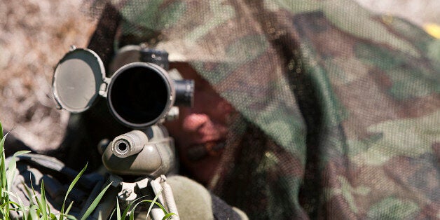 An unidentified marksman taking aim with his rifle.