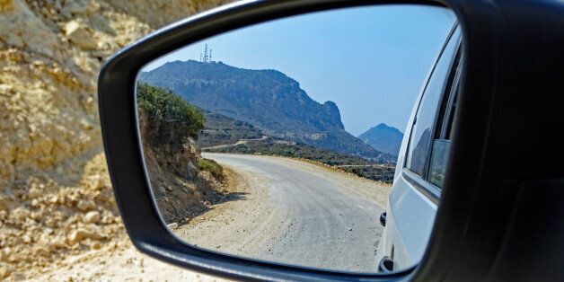 Landscape of the island of Kos (Greece) seen in the rear view mirror of a car