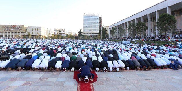 Albanian Muslims pray in Tirana's Skenderbej square on the first day of the Muslim festival marking the end of the holy fasting month of Ramadan in Tirana on June 25, 2017Muslims celebrate the Eid Al-Fitr holiday, which marks the end of the fasting month of Ramadan. / AFP PHOTO / Gent SHKULLAKU (Photo credit should read GENT SHKULLAKU/AFP/Getty Images)