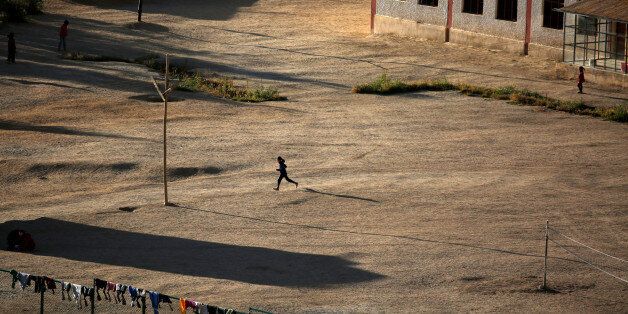 A girl runs across a school playground as the sun sets in Leh, the largest town in the region of Ladakh, nestled high in the Indian Himalayas, India September 24, 2016. REUTERS/Cathal McNaughton SEARCH