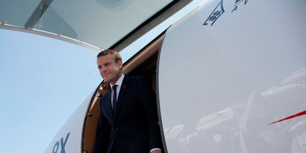 French President Emmanuel Macron leaves a Falcon 8X while visiting the Paris Air Show in Le Bourget, north of Paris, on June 19, 2017. Macron landed on June 19 at the Bourget airfield in an Airbus A400-M military transport plane to launch the aviation showcase, where the latest Boeing and Airbus passenger jets will vie for attention with a F-35 warplane, drones and other and high-tech hardware. / AFP PHOTO / POOL / Michel Euler (Photo credit should read MICHEL EULER/AFP/Getty Images)