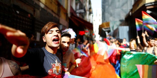 LGBT rights activists hold a rainbow flag during a transgender pride parade which was banned from the governorship, in central Istanbul, Turkey, June 19, 2016. REUTERS/Osman Orsal