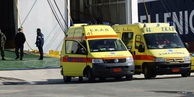 Ambulances are parked in front of the Cypriot-flagged ship Ionian King, which was used to evacuateg 1,280 people from Libya, in Souda Bay on the southern Greek island of Crete on March 6, 2011. Three Bangladeshi nationals died in Crete on March 6 when they fled from the Ionian King that was evacuating them from Libya. The Greek coastguard retrieved the bodies of two men who drowned at sea, while the third person died en route to a hospital, according to a press statement from the Merchant Marine. AFP PHOTO / Stringer (Photo credit should read STR/AFP/Getty Images)
