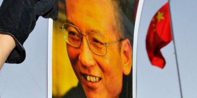 A protester holds an image of to jailed dissident Liu Xiaobo outside of the Chinese Embassy in Oslo December 9, 2010. The Nobel Peace Prize panel on Thursday defended its award to jailed dissident Liu as based on