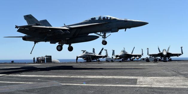 An F/A-18F Super Hornet lands on the US navy's super carrier USS Dwight D. Eisenhower (CVN-69) ('Ike') in the Mediterranean Sea on July 6, 2016.The US aircraft carrier is deployed in support of Operation Inherent Resolve, maritime security operations and theater security cooperation efforts in the US 6th Fleet area of operations. Air Wings embarked aboard conducted strikes against the Islamic State group in Libya , Iraq and Syria. / AFP / ALBERTO PIZZOLI (Photo credit should read ALBERTO PIZZOLI/AFP/Getty Images)