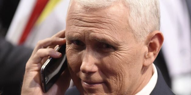 Republican vice presidential candidate Mike Pence speaks on his cell phone following the US vice presidential debate at Longwood University in Farmville, Virginia on October 4, 2016. / AFP / SAUL LOEB (Photo credit should read SAUL LOEB/AFP/Getty Images)