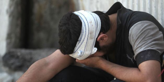 An Iraqi youth, who suffered injuries following a suicide attack as he was escaping the Old City of Mosul, cries on June 23, 2017.A suicide bomber blew himself up among civilians fleeing Mosul's Old City, where Iraqi forces are gaining ground against jihadists mounting a fierce but desperate defence, officers said. / AFP PHOTO / AHMAD AL-RUBAYE (Photo credit should read AHMAD AL-RUBAYE/AFP/Getty Images)