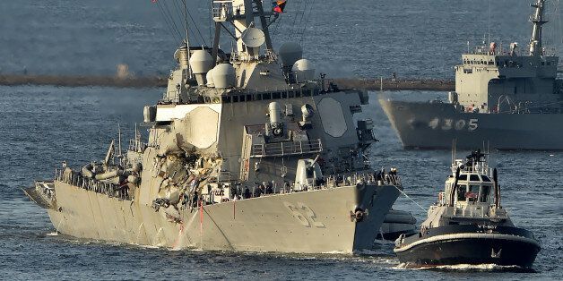 US Navy guided missile destroyer USS Fitzgerald arrves at its mother port US Naval Yokosuka Base, Kanagawa prefecture on June 17, 2017. The US and Japan launched a major search operation to find seven missing American sailors on June 17 after their navy destroyer collided with a container ship, crushing the side of the military vessel. / AFP PHOTO / Kazuhiro NOGI (Photo credit should read KAZUHIRO NOGI/AFP/Getty Images)