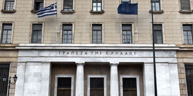 People walk past the National Bank of Greece in central Athens on May 18, 2017. Greece's parliament on May 18, 2017 was to approve a new round of austerity cuts, hoping to secure a pledge of debt relief and loan disbursements by the country's EU-IMF creditors this month. / AFP PHOTO / Eleftherios Elis (Photo credit should read ELEFTHERIOS ELIS/AFP/Getty Images)