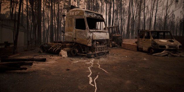 LEIRIA, PORTUGAL - JUNE 18: Burned vehicles stand near the road after a wildfire took dozens of lives on June 18, 2017 near Castanheira de Pera, in Leiria district, Portugal. On Saturday night, a forest fire became uncontrollable in the Leiria district, killing at least 62 people and leaving many injured. Some of the victims died inside their cars as they tried to flee the area. (Photo by Pablo Blazquez Dominguez/Getty Images)