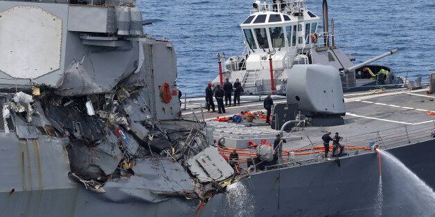 This picture shows damages on the guided missile destroyer USS Fitzgerald off the Shimoda coast after it collided with a Philippine-flagged container ship on June 17, 2017.The US Navy destroyer collided with ACX Crystal cargo ship off the coast of Japan, leaving seven crew members from the American vessel unaccounted for, the Japanese Coast Guard said. / AFP PHOTO / JIJI PRESS / STR / Japan OUT (Photo credit should read STR/AFP/Getty Images)